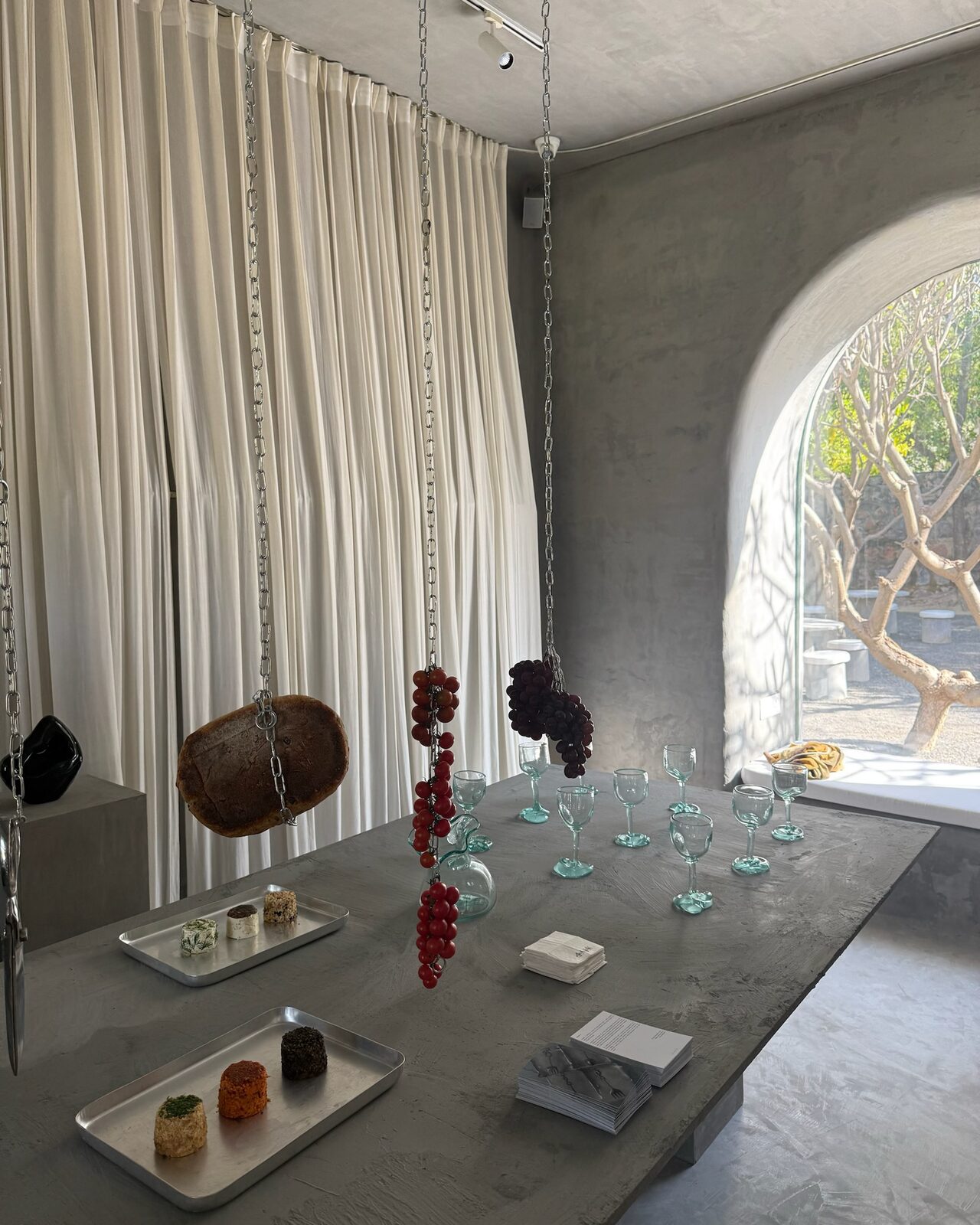 objects laid out on the long table by the arched window