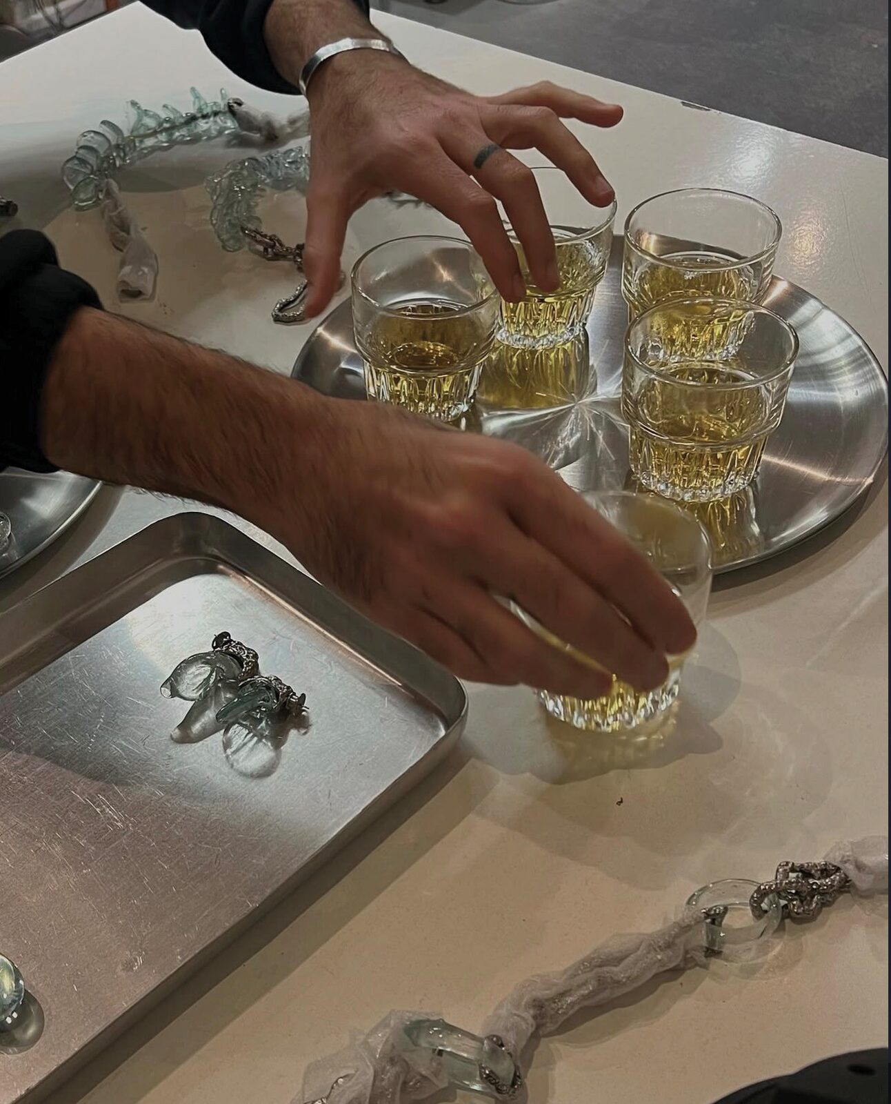 glasses lifted from a steel tray