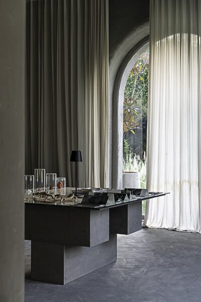 a dark table between curtains