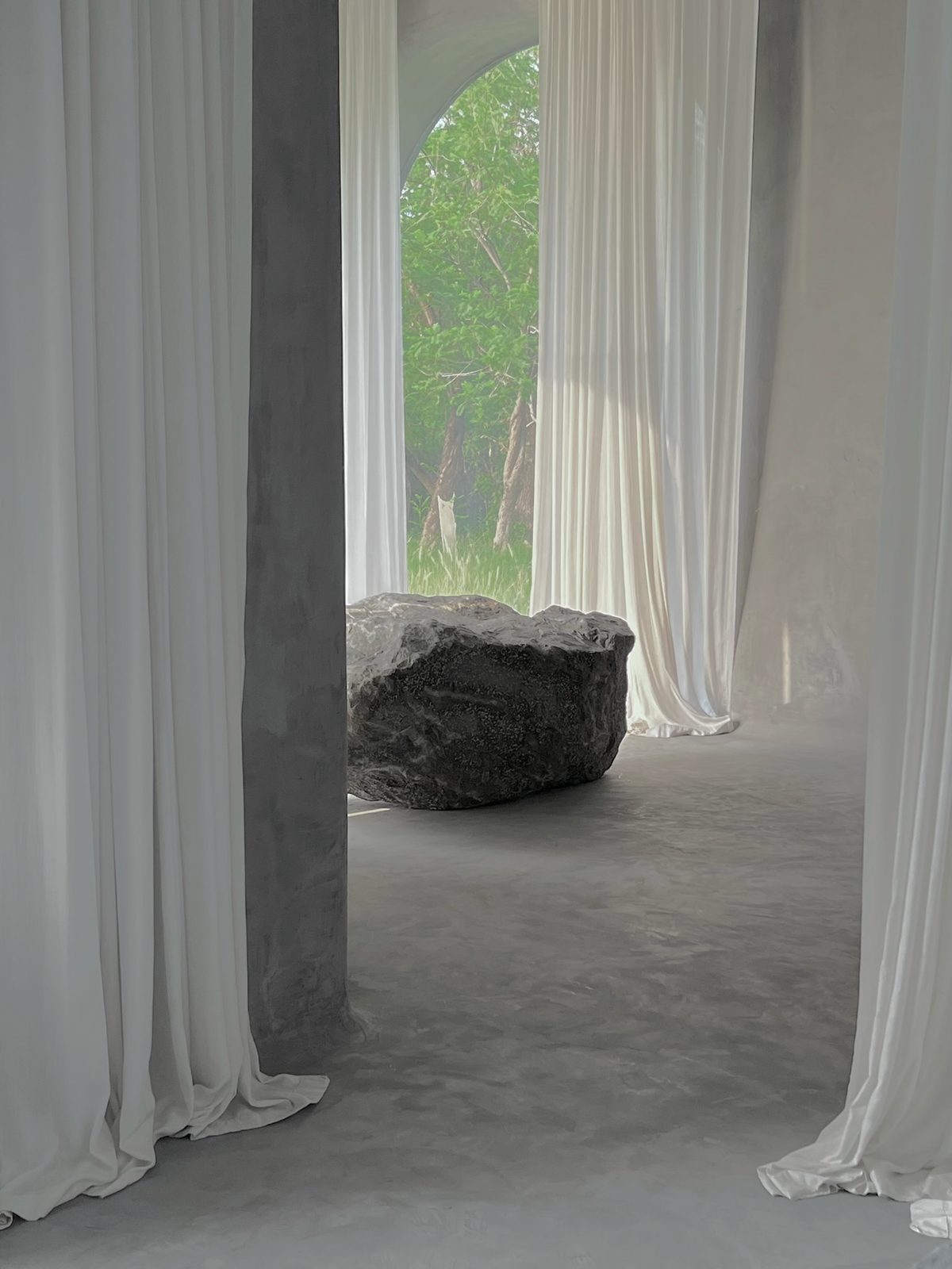 a stone between curtains